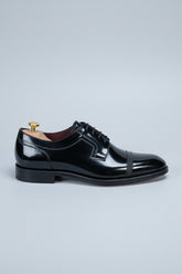 Black patent leather dress shoes with lace-up design and elegant classic style.